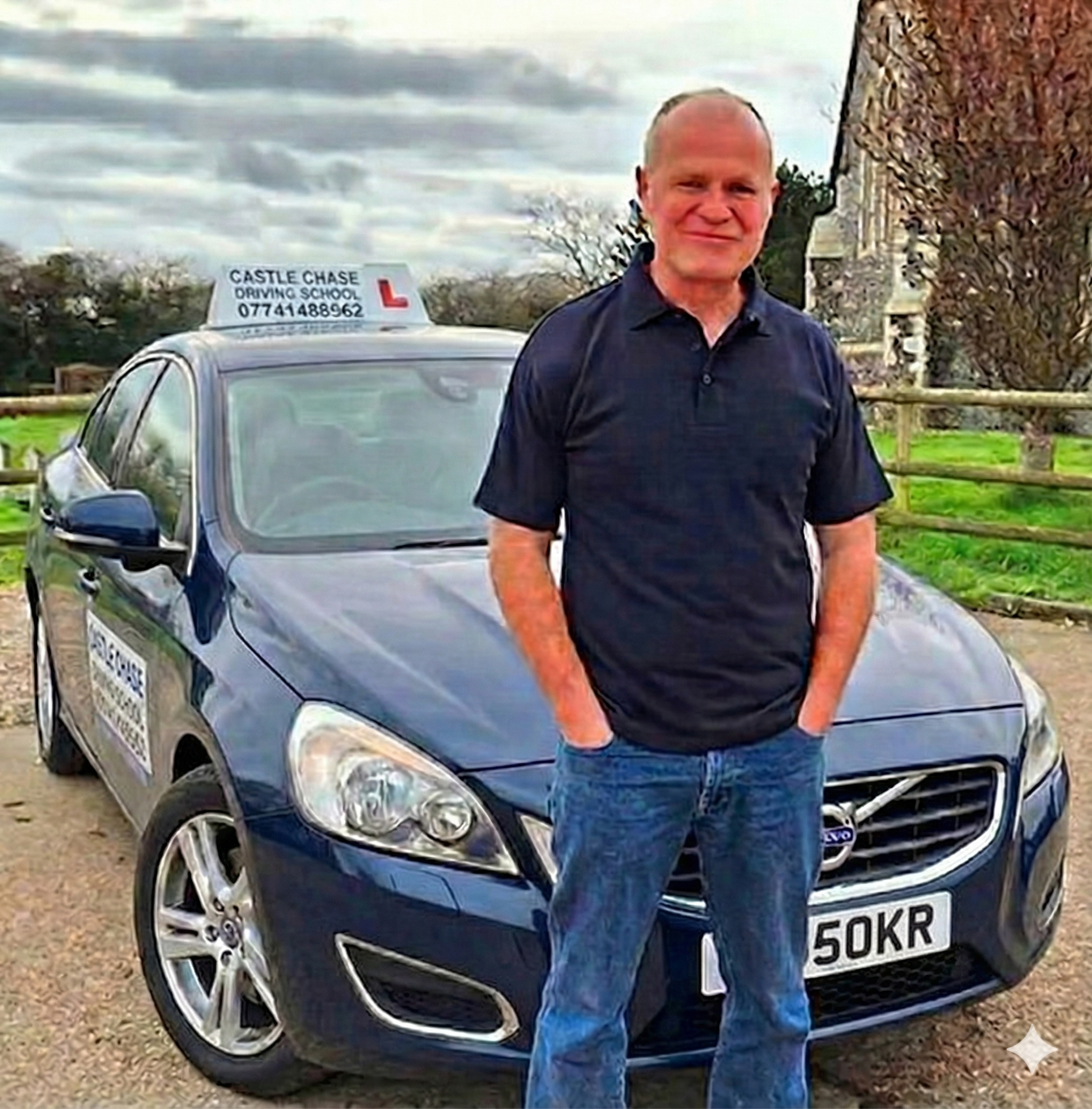 Darren Moor standing next to his Volvo driving school car